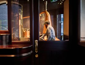 A person working at Woodward Street Distilling Company.