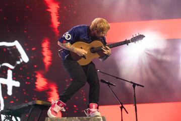 Ed Sheeran performing on stage.