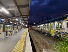 Two trains sit at platforms at Wellington train station.