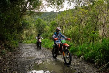Two people on motorbikes riding on the Karapoti trails.