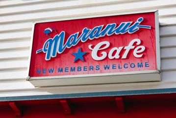 A red rectangular sign with blue and white lettering. It says "Maranui Cafe new members welcome".