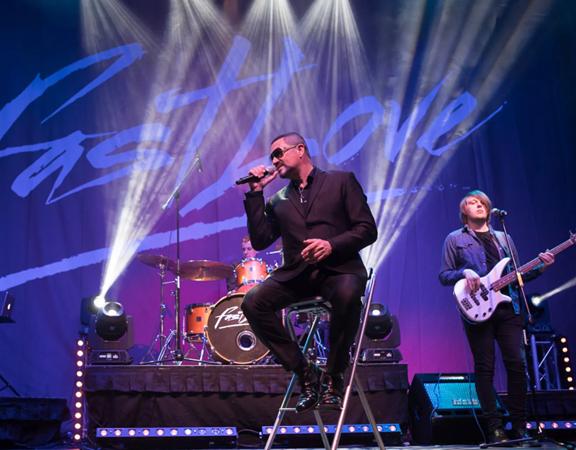 Fastlove, the George Michael tribute act performs on stage.