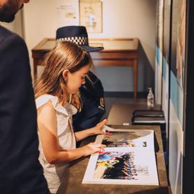 A young child looking through a book at the new Zealand police museum.