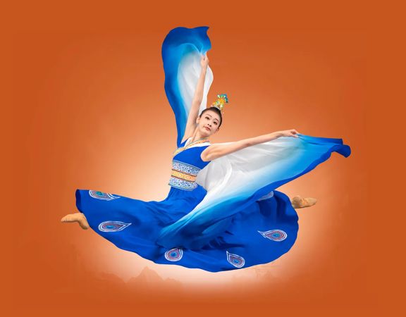 A Chinese dancer jumping with arms extended on an orange background.