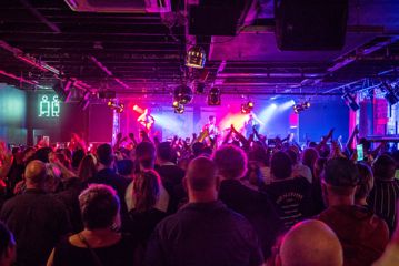 Looking over the crowd inside the busy San Fran club while a band plays under the Pink lights.