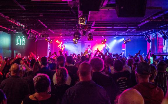 Looking over the crowd inside the busy San Fran club while a band plays under the Pink lights.