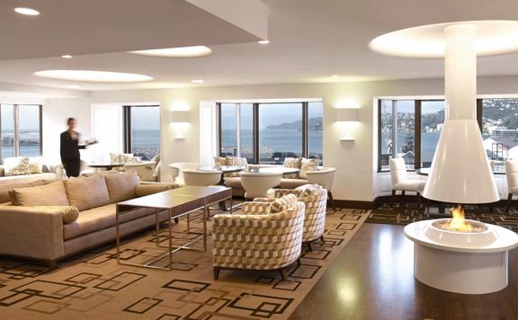 The Club InterContinental Lounge has views of Wellington Harbour, soft couches, and a fireplace.