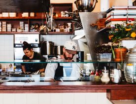 Two people working in the open plan kitchen at Dilly Dally