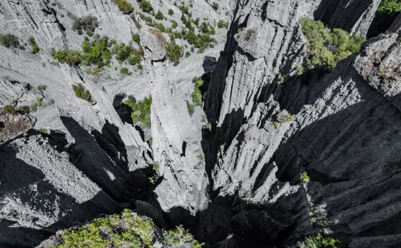 Image of the Pūtangirua Pinnacles. Taken from a drone, looking down on the large stalagmite structures.