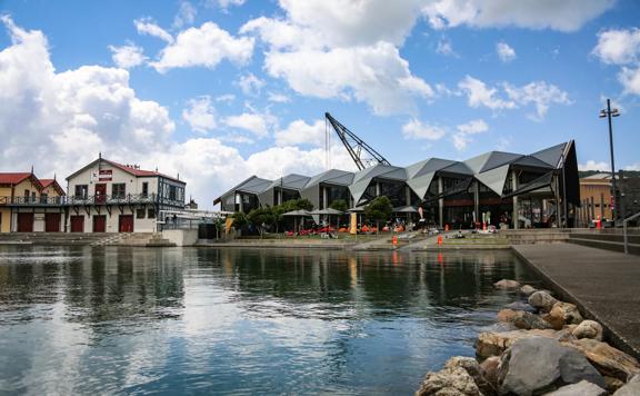 The exterior of Karaka Cafe at Te Wharewaka o Pōneke over the water.