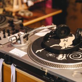 A vinyl record player with a pair of headphones laying on top at Xreeps Record Parlour, a record store in Petone, Lower Hutt, New Zealand.