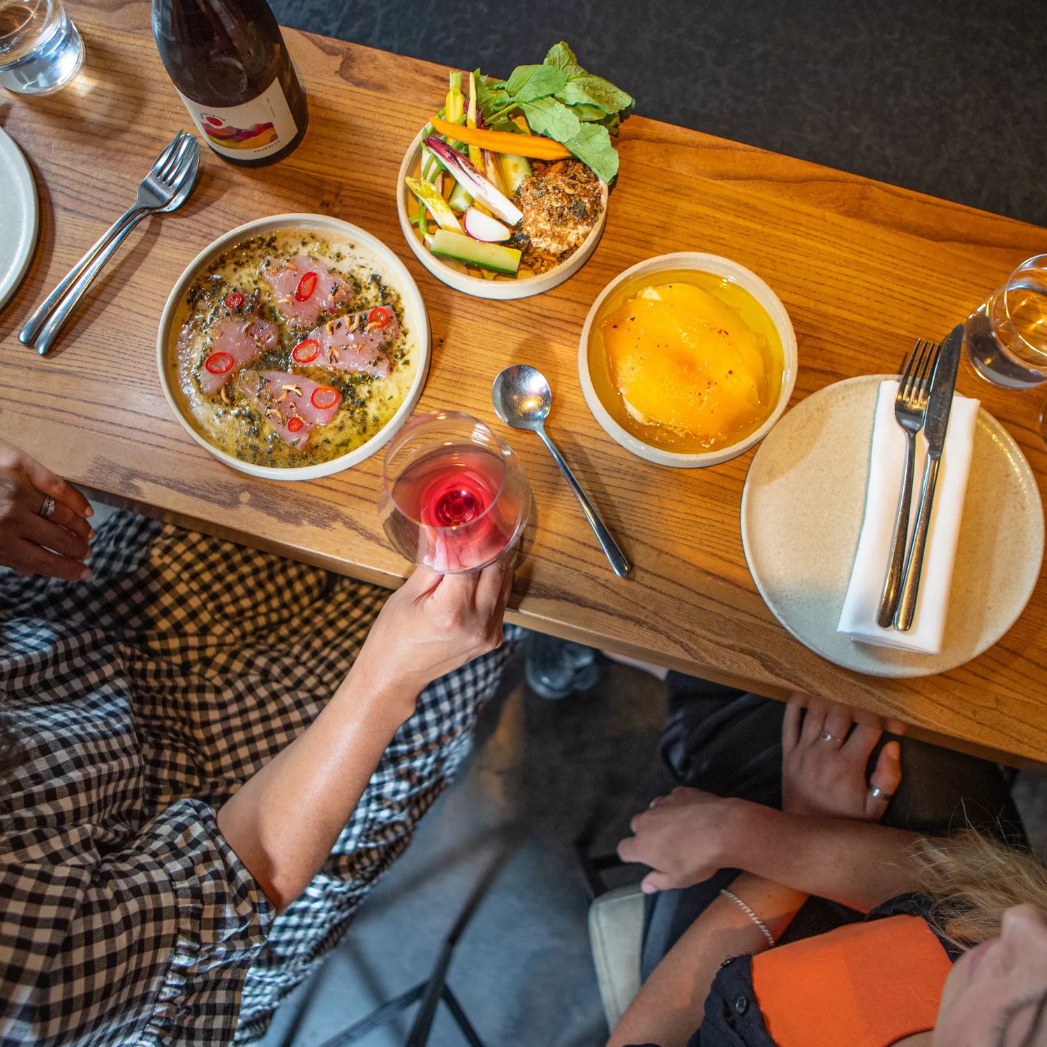 Customers enjoy food and wine at Highwater eatery.