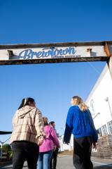 Group of people walking under Brewtown sign in Upper Hutt.