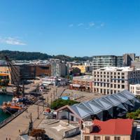 A drone shot of the Wellington Harbour on a sunny day. The Te Papa Museum, Wharewaka Function Centre  and The Boatshed venue are in view.