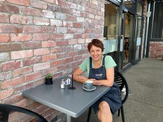 Shelley Rutene, the owner of Kāinga Eatery, sat outside her shop enjoying a cup of coffee.