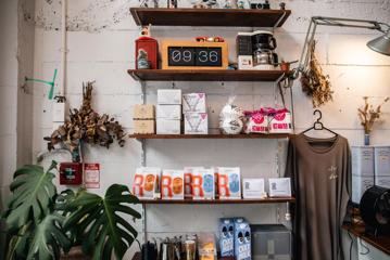 Wall shelving stocked with coffee paraphernalia for sale at Pour & Twist.