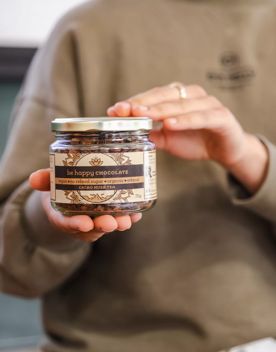 A jar of be happy chocolate cacao husk tea.