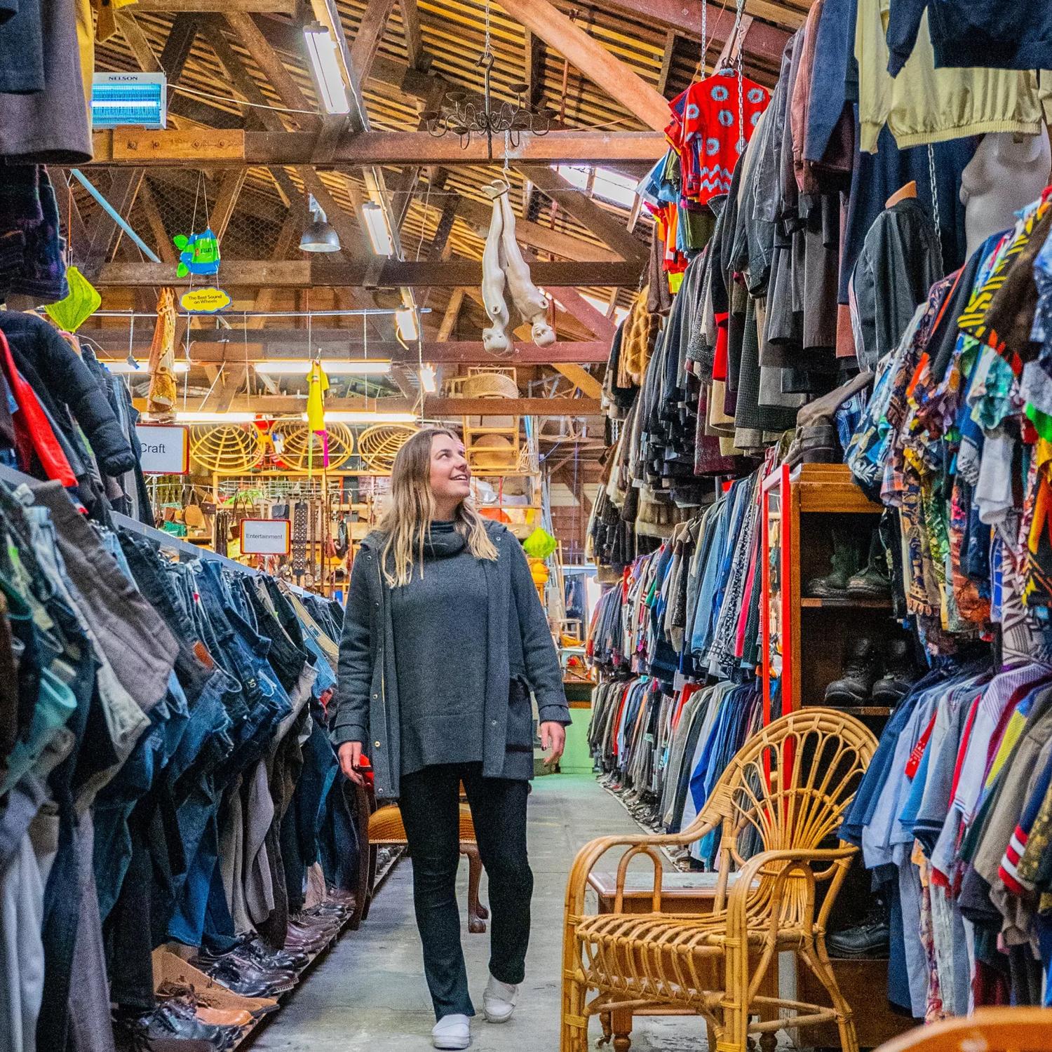 A person walking through the large array of vintage and second hand clothes at Helter Skelter.