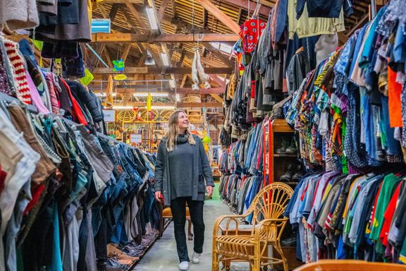 A person walking through the large array of vintage and second hand clothes at Helter Skelter.