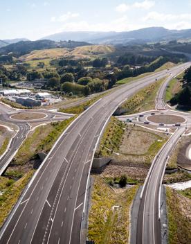 The 4 lane motorway of Transmission Gully, surrounded by green hills.